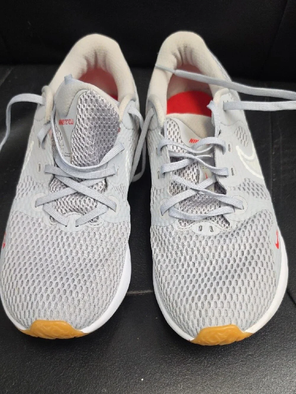 Nike Women's Light Gray Athletic Sneakers with Orange and Red Accents